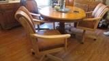 Large center base dining table four caster chairs