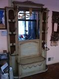 Oversized hall tree with antiqued/ distressed paint finish. Woven wicker panels, 8 metal hooks, hanging bar on topumbrella stands with drip trays on both sides flip up storage seat. Sorry photo doesn't show true colors -> stupid phone camera !