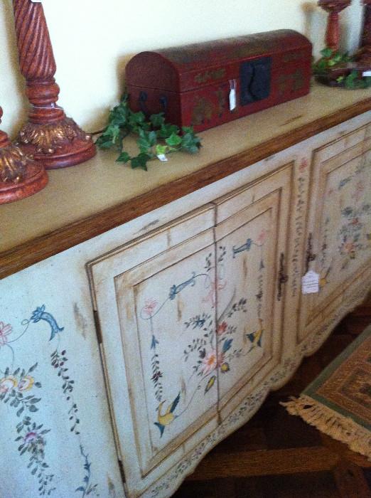             decorative items atop a painted credenza