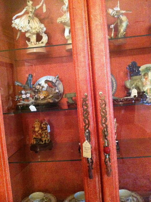         china cabinet filled with many decorative items