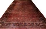 Lot#2080,SAROUK HAND MADE WOOL CARPET, W 14' 10", L 27' 3"Persian Sarouk, red field, navy border, closed floral motif. Circa 1930.