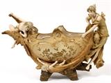 Lot#2085, ERNST WAHLISS PORCELAIN CENTERPIECE, CIRCA EARLY 1900'S, H 12.5", L 18", D 7"The large Austrian footed centerpiece featuring a mother holding a fishing net, being assisted by a child, raising a second child and fish.  Marked on the underside with the Wahliss crowned shield.