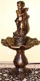 Lot#2140, BRONZE GARDEN FOUNTAIN W H 81", L 40" BOY WITH FISH.Brown patina with grape and vine design.  Atop the fountain is a cherubic boy holding a fish.