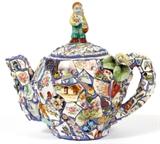 Lot#1009, LYNN MATTSON (1958-), MOSAIC TEAPOT, 1993, H 9 1/2", W 10"Lynn Cassiniero Mattson [American, b. 1958]. Mixed media mosaic, with porcelain fragments, jewelry, and metal. Signed and dated at underside, measuring H. 9 1/2" x 10".