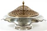 Lot#1023, CLARENCE A. VANDERBILT STERLING CENTERPIECE BOWL, H 8", W 13 1/2"Clarence A. Vanderbilt sterling silver footed bowl, having a gadrooned edge, decorated in incised foliage motif, with a pierced metal flower frog, stamped at the underside, including number 4002 (see additional photo).  Measuring H.8" x 13 1/2", and approximately 19.19tr.oz. in total weight.  Renowned American silversmith, Clarence A. Vanderbilt (active circa 1910 to 1930).