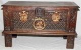 Lot#1050, E. EYMONAUD, FRENCH OAK BLANKET CHEST, C. 1900, H 31", W 51", D 19"Ernst Eymonaud (French late 19th-early 20th c.), having a hinged lid with molding on edge, carved front with painted family crests/shields on the front, in relief; carved front legs. Cast iron front lock (no key). Signed on the interior and back, "E Eymonaud, Paris, Modele Depose" (registered design).