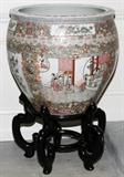 Lot#1065, CHINESE ROSE MANDARIN PORCELAIN FISH BOWL, H 19", DIA 20 1/2", ON A STAND.Decorated with figural panels within floral borders, raised on a separate wood stand. Circa 1980.