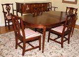 Lo#1155, HENKEL HARRIS MAHOGANY DINING SUITE, EIGHT PIECES.The oval table is H 29.5", L 64", D 42", having satinwood string and bell flower inlay and accompanied by three leaves each 12" and table pads.  The sideboard is H 38.5", L 66", D 24.75 and features two central doors flanked by doors on each side.  The chairs include two arm chairs and four side chairs, each with striped upholstery.