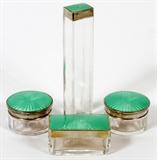 Lot#1241, GERMAN ENAMELED SILVER & GLASS COSMETIC JARS, FOUR, H 1 1/2"-6 1/2"All having .935 silver lids, with green guilloche enamel decoration; includes two round jars, 1 rectangular jar, and 1 tall square jar. Measuring H. 1 1/2" to 6 1/2".