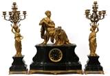 Lot#30, FRENCH GILT BRONZE & MARBLE CLOCK GARNITURE, SET OF THREE PIECES.Set includes 1 mantel clock, stamped at interior " Dugol, Atre Fabt, Paris", and 2 five-light candelabra, H.24 1/2"; all featuring classical female figures in gilt bronze, raised on black marble bases.