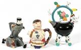 Lot#134, NOVELTY PORCELAIN TEAPOTS, THREE, H 11"-16"Includes 1 bell boy figural teapot, measuring H. 11", 1 Bacchus teapot, and 1free form teapot, raised on four legs, circa 1980s, signed at underside "Solla", measuring H. 16".