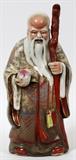 Lot#160, CHINESE PORCELAIN FIGURE OF AN ELDER, H 14"Elderly man with walking stick holding a piece of fruit. Actual size 14 1/2"; unsigned;