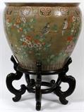 Lot#163, CHINESE PORCELAIN COI BOWL WITH STAND H 20", DIA 24"having a light green ground with birds and flowers on the exterior; coy fish and lily pads on the white interior. Mounted on 10" H. rosewood stand. Printed label inscribed: "Porcelain Body Made In Taiwan Hand Painted And Re-fired In Hong Kong By Maitland Smith" on underside.