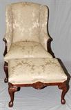Lot#251, CHIPPENDALE STYLE MAHOGANY UPHOLSTERED ARMCHAIR W/ OTTOMAN, H 42" W 20"Raised on cabriole legs with carved floral motif. Upholstered in champagne floral and leaf patterned fabric.