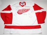 Lot#265, DETROIT RED WINGS, 1997-98, WHITE REPLICA 'AWAY' JERSEY, TEAM SIGNED, 11 AUTOGRAPHS.includes signatures of Nick Lidstrom, Chris Draper, Larry Murphy, Martin La Pointe, Jamie Pusher, Devin Hodson, Doug Brown, Chris Osgood, Kirk Maltby, Bob Rouse and Mike Knuble. Eleven autographs.