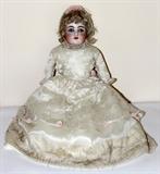 Lot#354, GERMAN BISQUE DOLL, C. 1910, L 22"Stamped "Dep 154.9" at the neck. Open mouth with teeth. Open shut eyes. Period satin costume with pink roses and embroidery.