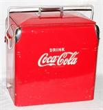 Lot#379, VINTAGE COCA COLA COOLER, H 17", L 17", D 12"Having an ice compartment and a full length tray in the interior and a bottle opener on the exterior. Pivoting rod carry handle that latches over the chrome handle on the lid securing the lid to the cooler.