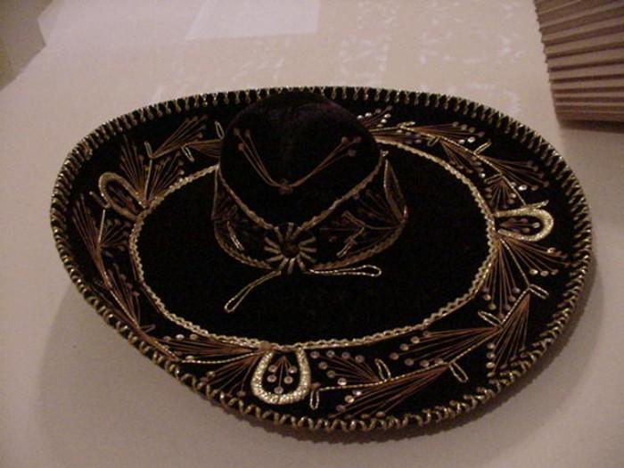 Several vintage sombreros, heavy and with intricate needlework