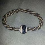 Spiral rope bangle bracelet. gray and ivory with a lamp worked bead in the center. Handmade by Joanne Cassulo. Bracelet is roughly 9 inches and should fit a 6.5-7.5 inch wrist comfortably. This bracelet is made using the spiral rope stitch and is very comfortable to wear
Size: 9"
Donor: Joanne Cassulo
Shipping: Yes, paid for by donor