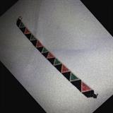 A peyote stitch bracelet in a diamond shape design. Black background with diamonds in teal and rose colors edged in gold. Clasp is 14 karat gold filled. Bracelet length is 7.5 inches end to end, including clasp.
Size: 7 1/2"
Donor: Joanne Cassulo
Shipping: Yes, paid for by donor 