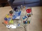 variety of signed art glass on a chrome & glass coffee table