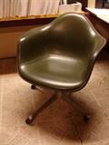 Herman Miller Eames swivel-tilt chair with casters, with molded fiberglass body covered in pieced and stitched Naugahyde upholstery