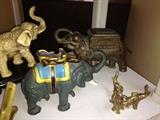 Gray cast iron is a vintage mechanical bank.  The elephant upper left is a cigarette dispenser!