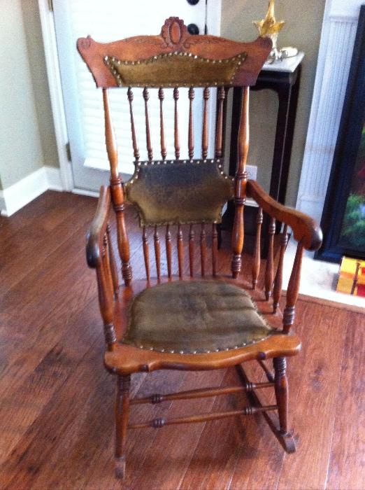Antique rocking chair with tall back, double set of spindles and leather insets.