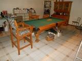 Pool table sold with cue holder, lamp and two high chairs.