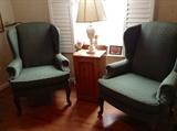Pair of green upholstered wing back chairs