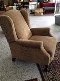 Wing back easy chair that reclines.