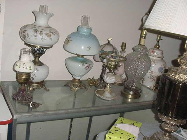More of the dozens of old oil lamps, and electric ones as well..we have boxes of oil lmpas, old glass shades, and lamp parts as well