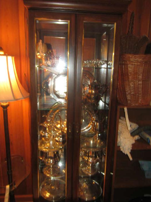 this curio is full of silver trophies and awards won over the years by Charles Lewis, Jr. , and Charles Lewis, lll