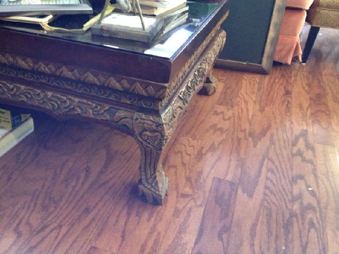 heavily carved coffee table under glass from the phillipines