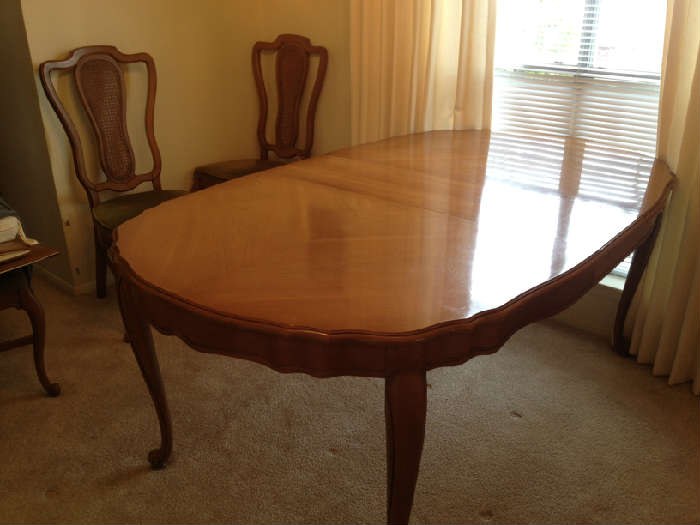 nice french table with two additional leaves and six chairs, also a custom pad