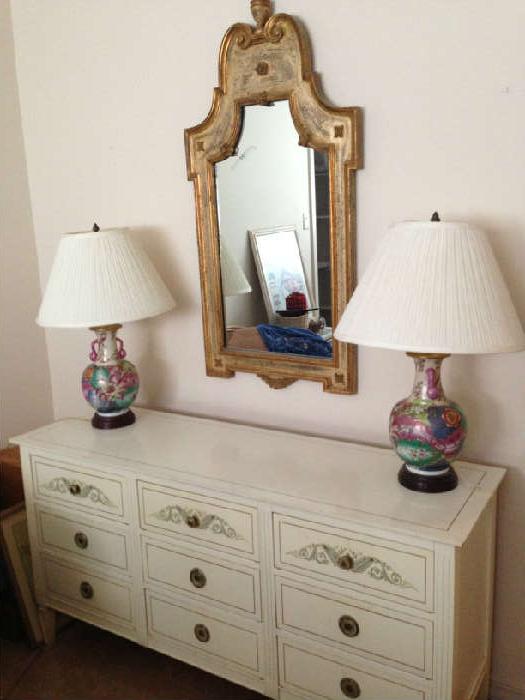 dresser with nicely painted accents, a pair of reproduction tobacco leaf lamps