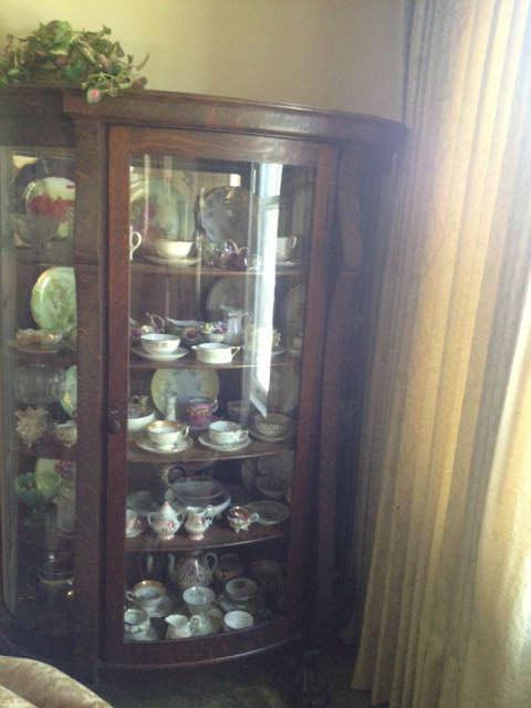 another view of the oak china cabinet with carved feet