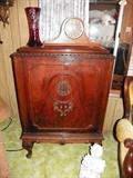 Nice vintage cabinet that was converted to hold a T.V. Seth Thomas working clock & a beautiful 1920's ruby red cut glass vase.