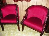 Pair of red velvet side chairs with carved swan arms.