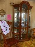 Bowed glass curio cabinet with light. Nice large rocking chair. Very comfortable!