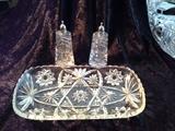 C7  American Brilliant Period Cut Crystal 12” long and 6 “ wide serving dish with Saw tooth edge and Starburt  diamond cut details, along with and crystal oval 5 ½” X 2 ½” Salt and Pepper shakers  with silver platted  tops (Excellent Condition)