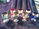 C10    Striking set of 7, Hand Painted with gold rimed Brandy snifters  ( 2 Blue, 2 Green, 1 Red, 1 Amber & 1 Burgundy)