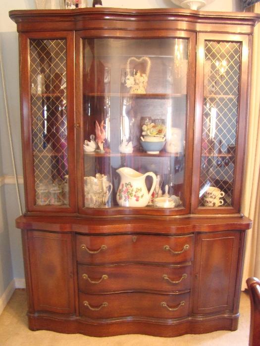 Antique china cabinet that matches dining table with three drawers, two side storage cabinets, and three shelves at top