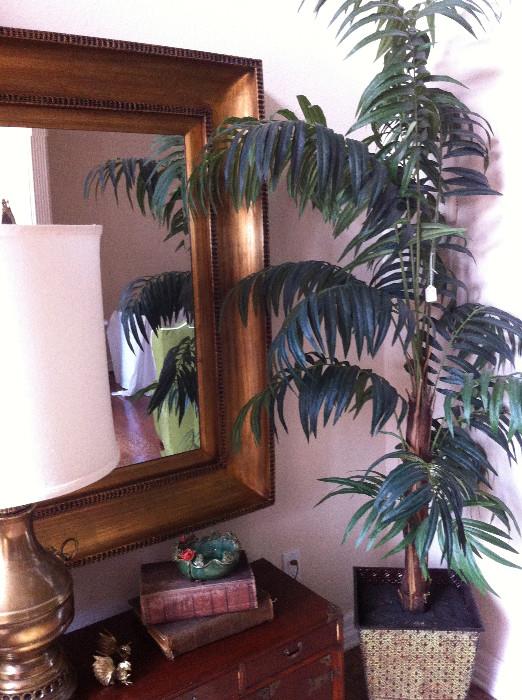                     Large mirror and artificial palm