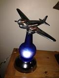 Lighted Chrome Airplane hovering oer a blue Glass Globe Light which is embossed World's Fair   SOLD1939,,,,Very Cool