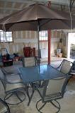 A Martha Stewart patio set with umbrella, consisting of:
Square table
Chaise lounge
Four swivel chairs