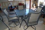 A Martha Stewart patio set with umbrella, consisting of:
Square table
Chaise lounge
Four swivel chairs