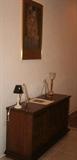 The Kiss print, sideboard, small lamps 