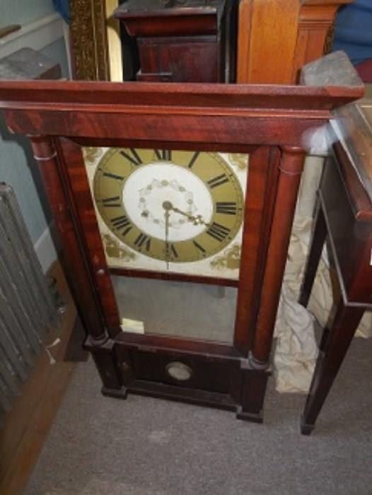 This is the Amber Gerald Arnold Jr. Clock with brass dial, round columns and is weight driven. 