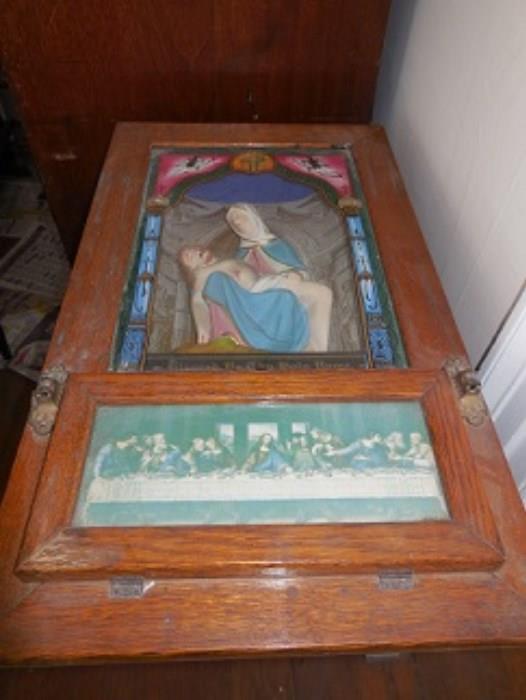 The oak cabinet has the communion set in the drop down cabinet in the lower section.  The painting on the figures and glass is well done and early.